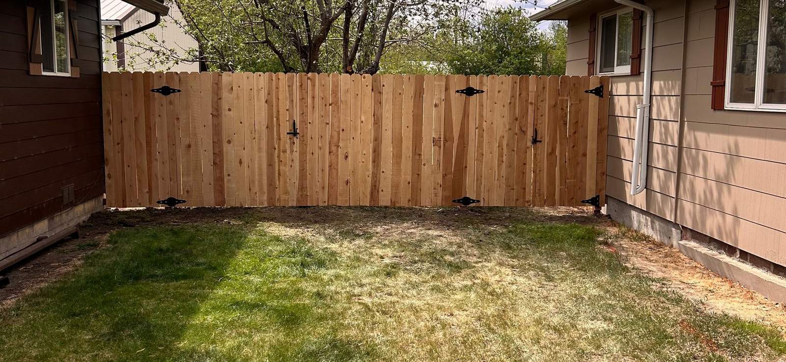 New cedar horizontal privacy fence along a home in Montana