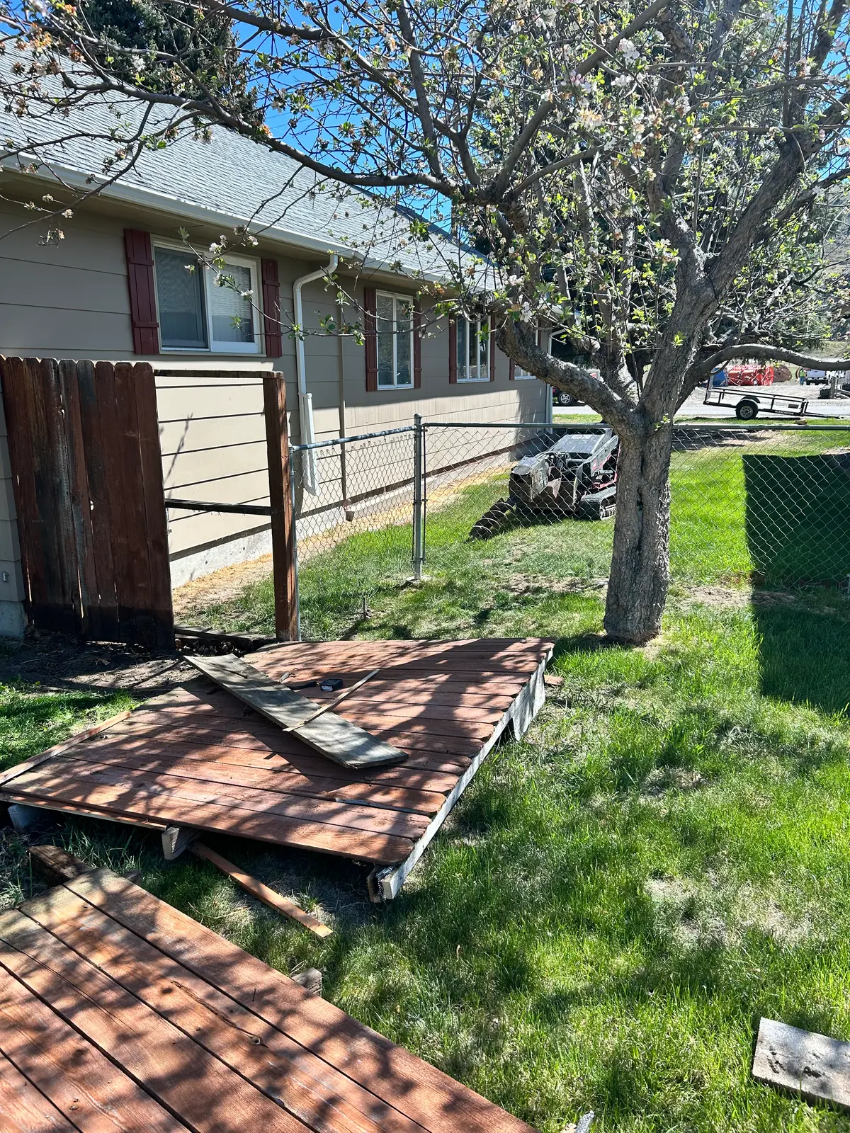 Dilapidated wood and chain-link fence, before replacement
