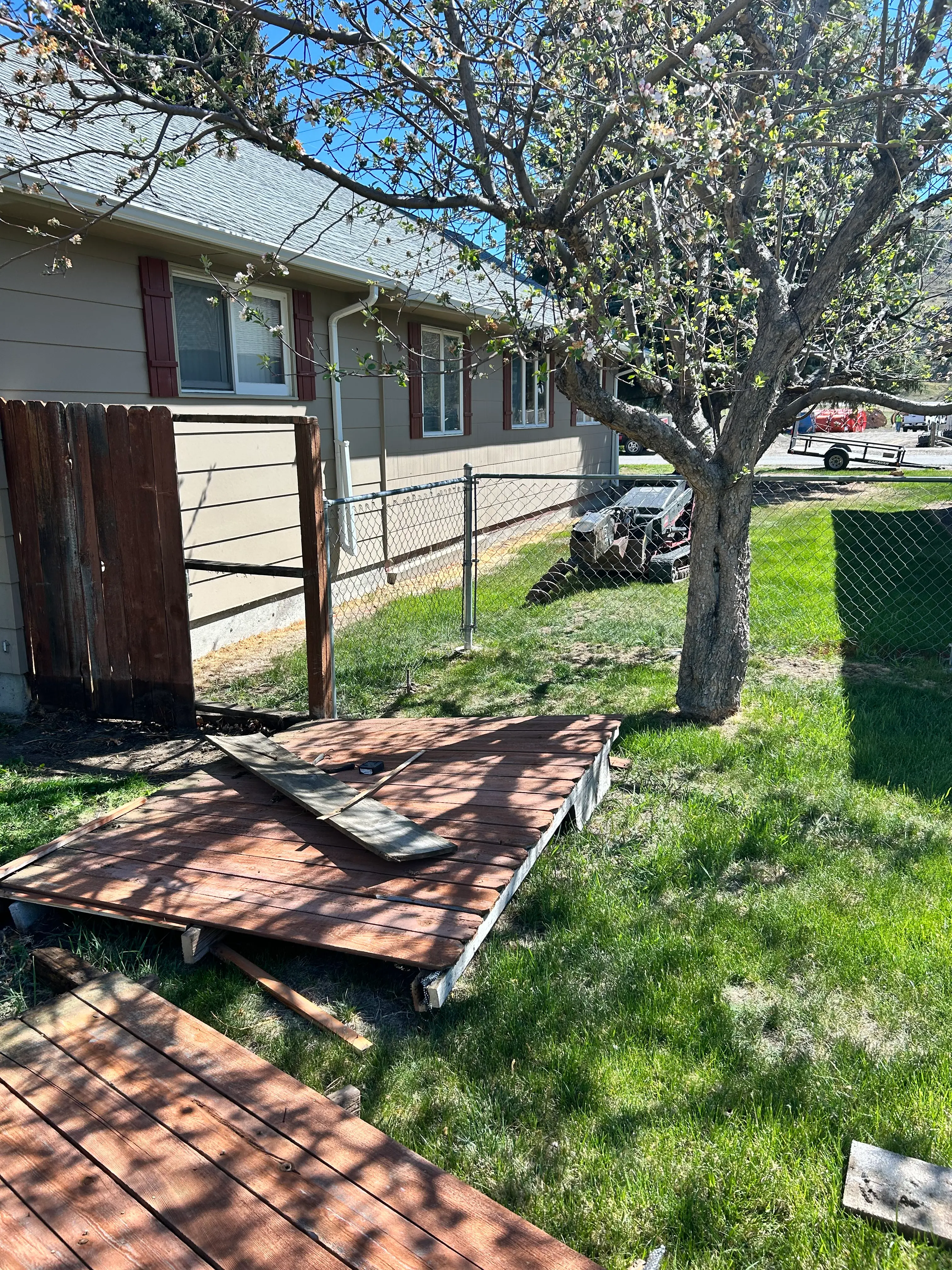 Dilapidated wood and chain-link fence, before replacement